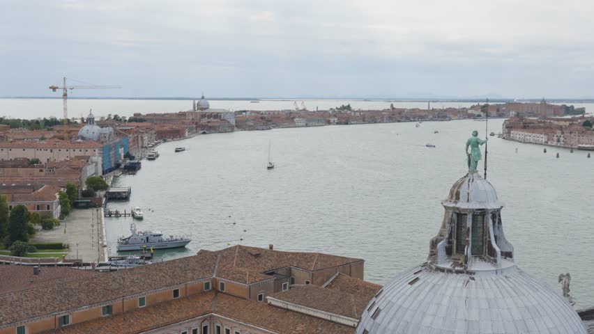 Panoramic view of Venice from the San Giorgio Maggiore Bell Tower, overlooking St Mark’s Square, the Basilica, the Campanile, and boats moving across the Venetian lagoon.