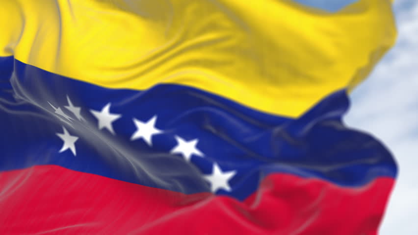 Close-up of Venezuela national flag waving on a clear day. Tricolor of yellow, blue and red with an arc of eight white stars. Seamless 3d render animation. Slow motion loop. Selective focus
