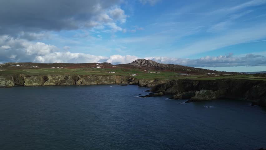Holyhead mountain rugged welsh coastline and south stack lighthouse aerial view across headland