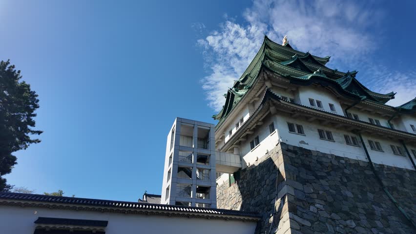 Nagoya castle, Nagoya, Aichi, Japan, Historic Japanese castle with modern elevator tower under blue sky