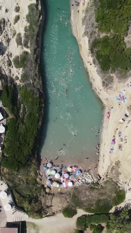 Top-down drone flyover of Canal d’Amour, showing swimmers, sunbathers, and the unique layered rock formations of Sidari’s coastline.
