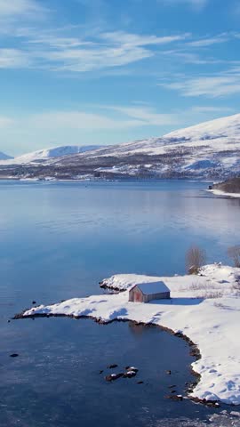 Experience the breathtaking beauty of Tromso, Norway during winter. Discover the serene beaches, icy waters, and snow-capped mountains and fishing village.
