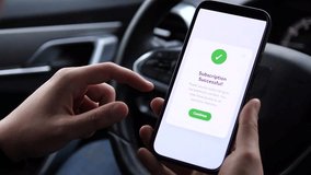 A user receives instant confirmation of his premium subscription upgrade while in his vehicle. This scene demonstrates the ease of accessing exclusive content through mobile subscriptions, ideal for - Powered by Shutterstock - Get 15% off with code: PIKWIZARD15