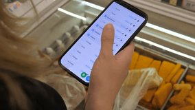 Hands of a contemporary consumer using a digital list while navigating store aisles. This relatable scene captures how technology integrates into daily shopping routines, excellent for supermarket - Powered by Shutterstock - Get 15% off with code: PIKWIZARD15