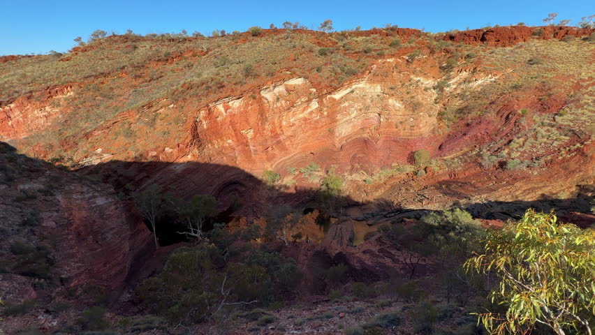 Landscape view of fresh water flowing through the iconic Hamersley Gorge at Karijini National Park Pilbara region in Western Australia.