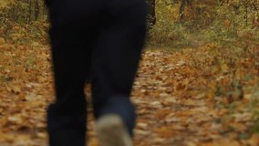 Young muscular man in black cap and sunglasses with heart rate monitor on his chest goes along path strewn with yellow leaves in an autumn forest. - Powered by Shutterstock - Get 15% off with code: PIKWIZARD15