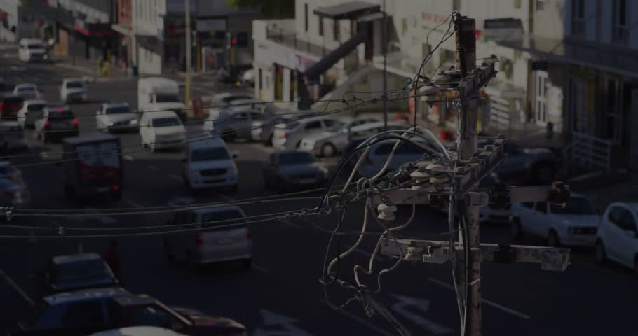 Wooden pole remaining fixed while data feed animating bars, lines on junction to show market trend. Urban, street, cityscape, traffic, intersection, daylight, elevated