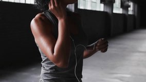 Woman holding earbud and tuning device, brain network animating across face torso for training. Warehouse, industrial, headset, fitness, neural, focus, daylight - Powered by Shutterstock - Get 15% off with code: PIKWIZARD15