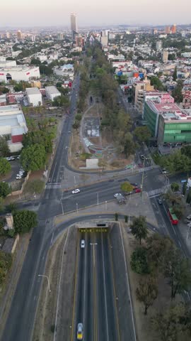 Aerial vertical shot advancing along linear park over Lazaro Cardenas Avenue in Guadalajara, Mexico