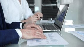 Business professionals examining laptop charts and bar graphs during a modern office meeting, discussing sales performance, market trends, financial analysis and strategy development - Powered by Shutterstock - Get 15% off with code: PIKWIZARD15