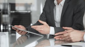 Business people collaborating during a meeting using a modern digital tablet, close up. Discussing strategies and analyzing data in a professional office environment - Powered by Shutterstock - Get 15% off with code: PIKWIZARD15