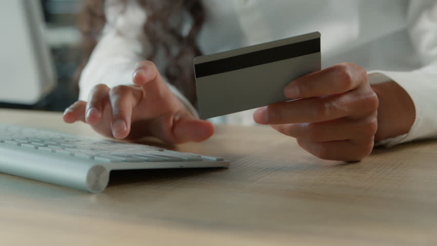 Close-up female hands typing keyboard with credit card unrecognizable business woman using virtual bank service typing computer unknown businesswoman girl online buying corporate shopping in office - Powered by Shutterstock - Get 15% off with code: PIKWIZARD15