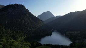 4K Aerial Drone video of Alpine lake Thumsee with turquoise water and lush green woods surrounded by tall mountains at sunset golden hour in Bad Reichenhall Germany - Powered by Shutterstock - Get 15% off with code: PIKWIZARD15