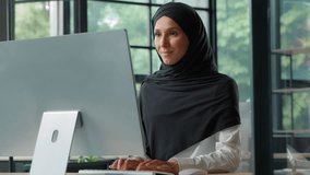 Happy Arabian Muslim business woman typing computer smiling looking at camera Islamic businesswoman female girl in hijab working pc smile posing at table using internet job work project positive glad - Powered by Shutterstock - Get 15% off with code: PIKWIZARD15