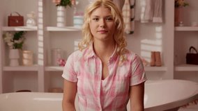 Excited shocked amazed Caucasian woman girl female holding showing lollipop amazing wonder with candy in shape of heart demonstrates sugar striped lollypop looking at camera in pink candy bathroom - Powered by Shutterstock - Get 15% off with code: PIKWIZARD15