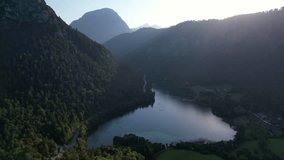 4K Aerial Drone video of Alpine lake Thumsee with turquoise water and lush green woods surrounded by tall mountains at sunset golden hour in Bad Reichenhall Germany - Powered by Shutterstock - Get 15% off with code: PIKWIZARD15