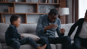 African American family carefree sons hitting dad with pillows little cheerful naughty boys children kids with father fighting laughing talking having fun at couch at home game fight with cushions - Powered by Shutterstock - Get 15% off with code: PIKWIZARD15