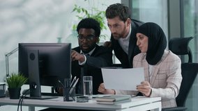 Multicultural business colleagues teamwork in office multiracial three co-workers working together diversity partners talking analyzing data in computer and papers documents meeting brainstorming - Powered by Shutterstock - Get 15% off with code: PIKWIZARD15