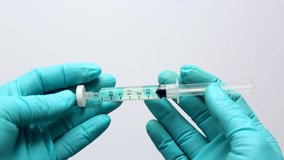 A scientist's hand grips a glass autosampler vial as a liquid sample is filtered through a microsyringe fitted with a filter membrane, removing particulates before HPLC or LC-MS analysis. - Powered by Shutterstock - Get 15% off with code: PIKWIZARD15