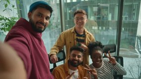 Business casual startup team in office meeting joy fun smiling making selfie photo together enjoying teamwork in friendly coworking posing for video call vlog take picture multiethnic four people - Powered by Shutterstock - Get 15% off with code: PIKWIZARD15