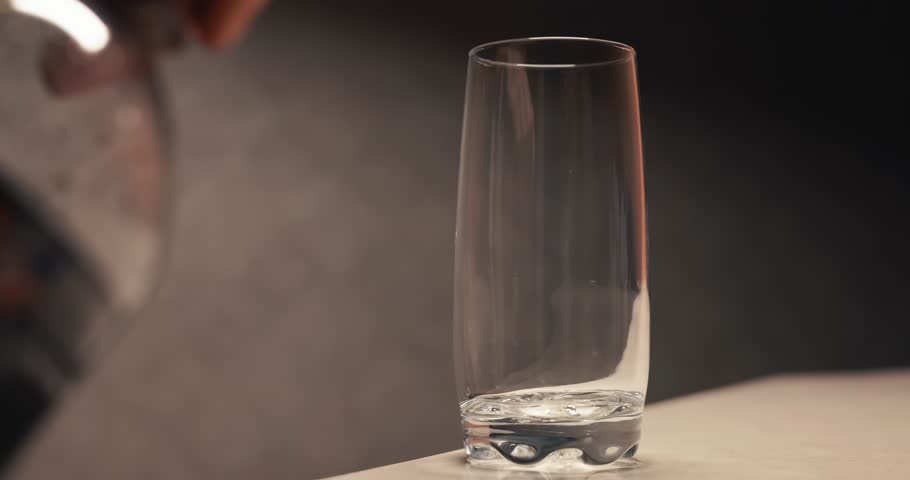 Pouring cola with bubbles into a glass. Video contains original audio.