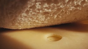 Womans hands assemble a cheese sandwich in an extreme close up Camera pulls back revealing a cozy breakfast table with fresh oranges, bread, and a coffee cup - Powered by Shutterstock - Get 15% off with code: PIKWIZARD15