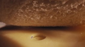 Pull back shot reveals a woman in a cozy pink sweater assembling a cheese sandwich on a wooden table set for a simple, healthy breakfast with sliced oranges - Powered by Shutterstock - Get 15% off with code: PIKWIZARD15