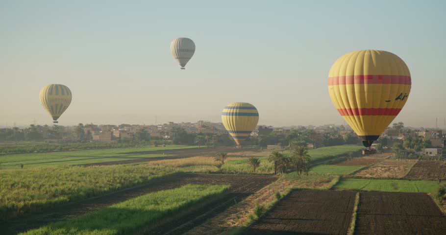 Hot Air Balloon landing over Sunrise in Luxor, Egypt
