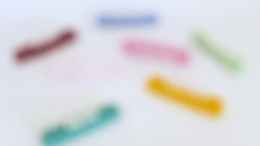 A group of cloud-shaped candles with colorful, emotive words on a white background inside a photo studio in Neiva, Huila, Colombia. Concept of objects and copy space