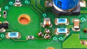 Technician desolders and removes a surface mounted component using a soldering iron on the printed electronic circuit board - Powered by Shutterstock - Get 15% off with code: PIKWIZARD15