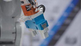 A robotic gripper is displayed at a technology exhibition, highlighting innovations in automation and robotics. Modern design - Powered by Shutterstock - Get 15% off with code: PIKWIZARD15