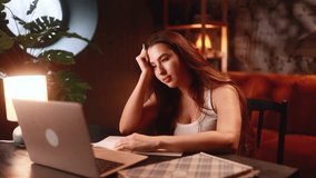 tired woman at desk studying and rubbing eyes under warm lamp glow, laptop open with notes, notebook and pen on table, deadline pressure and exhaustion, solitary cozy home workspace - Powered by Shutterstock - Get 15% off with code: PIKWIZARD15