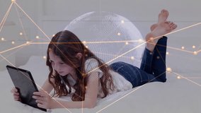 Girl lying on bed tapping tablet, causing globe, nodes and code overlay, smiling while learning. Child, bedroom, device, screen, education, curiosity, focus - Powered by Shutterstock - Get 15% off with code: PIKWIZARD15