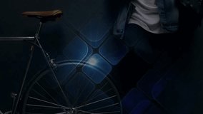 Male commuter leaning on wall holding phone, tapping screen and demoing blue tech overlay by bike. Bicycle, urban, smartphone, tiles, neon, minimalist, futuristic - Powered by Shutterstock - Get 15% off with code: PIKWIZARD15