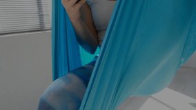 Woman tapping phone in blue hammock, activating digital globe into network lines for tech designers. Holographic, overlay, suspended, connectivity, minimalist, modern, interior - Powered by Shutterstock - Get 15% off with code: PIKWIZARD15