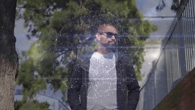 Man walking sidewalk and activating tech sphere appearing over torso while scanning surroundings. Urban, pedestrian, futuristic, digital, holographic, glow, nodes - Powered by Shutterstock - Get 15% off with code: PIKWIZARD15