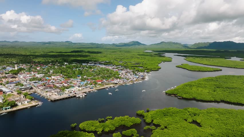 Coastal town surrounded by mangrove forest with winding rivers leading to the sea. Del Carmen. Siargao, Philippines.