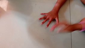 Top view of four diverse children's hands interacting on a bright floor, showing teamwork and early education. Perfect for concepts like friendship, learning, and togetherness. - Powered by Shutterstock - Get 15% off with code: PIKWIZARD15