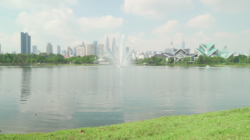 Awesome Kuala Lumpur skyline. The Petronas Twin Towers are reflected in water. Amazing view of scenic lake in a city park of Kuala Lumpur, Malaysia. Beautiful cityscape.