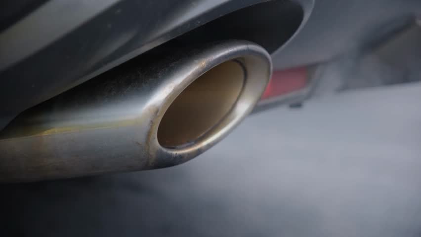Close-up of car exhaust fumes from gasoline or diesel vehicles, highlighting pollution, air quality, and environmental impact.