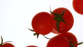 Close-up fresh red cherry tomatoes moving and splashing in water in slow motion - Powered by Shutterstock - Get 15% off with code: PIKWIZARD15
