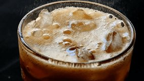 Refreshing cola with ice cubes pours into a glass, creating fizzy bubbles and a sparkling carbonated drink perfect for a thirst-quenching moment. - Powered by Shutterstock - Get 15% off with code: PIKWIZARD15