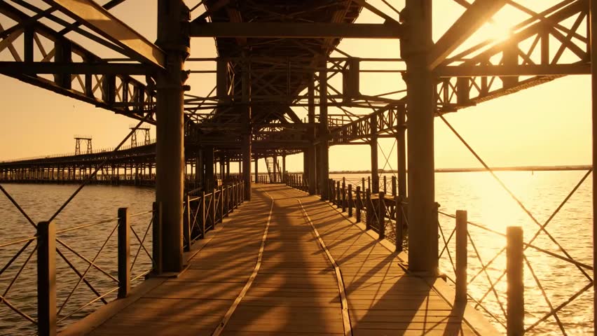 “Sunset over a historic commercial pier, capturing warm light, industrial architecture, and scenic reflections on the water at the Rio Tinto pier.”