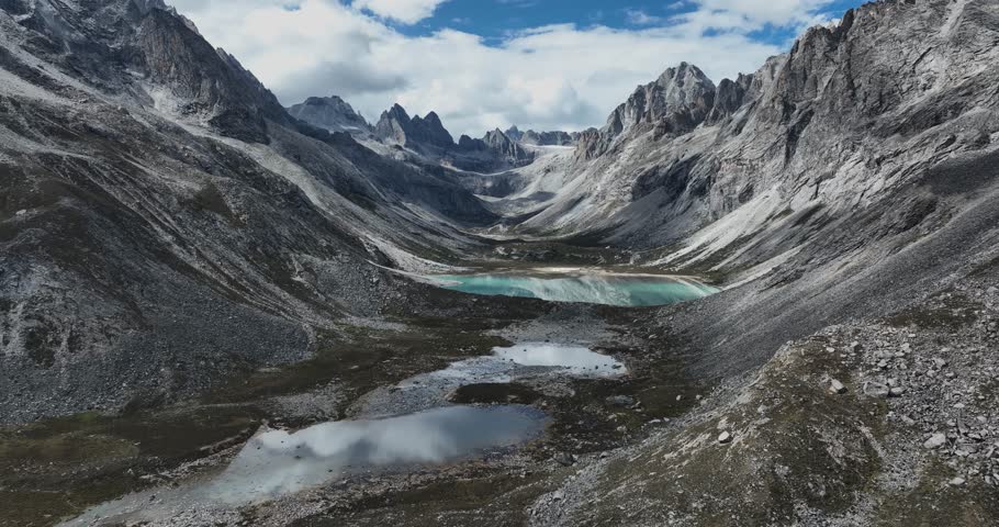 Aerial view of beautiful high altitude lake and snow capped mountain landscape