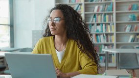 Latina Hispanic woman student use laptop technology library female girl typing on computer gadget cyberspace virtual project diploma homework elearning modern study smart education college university - Powered by Shutterstock - Get 15% off with code: PIKWIZARD15