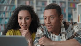 Online success laptop multiethnic couple students giving high five happy African American man Arabian woman using computer device in library project learn task female male study celebrating win result - Powered by Shutterstock - Get 15% off with code: PIKWIZARD15
