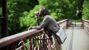 Man Drinking Coffee On Bridge With Bicycle. Commuter Taking Break Outdoors. Urban Lifestyle And Sustainable Transport. Enjoying Coffee Break. City Commute Morning Routine. Takeaway Coffee Cup Commute - Powered by Shutterstock - Get 15% off with code: PIKWIZARD15