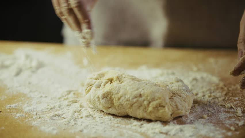Chef Preparing Bread Or Pasta Dough. Bread Making Process Gourmet Recipe. Dusting Flour On Raw Dough. Baking Ingredient Making Homemade Food. Home Cooking Fresh Dough Texture. Domestic Cooking Dough