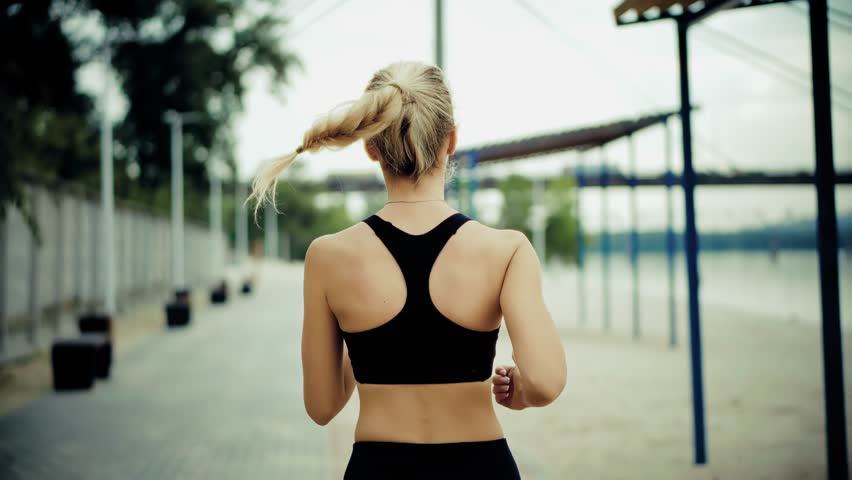 Runner Jogging On City Embankment. Athlete In Motion, Fitness Training And Healthy Lifestyle. Cardio Workout Outdoors, Woman Exercising. Endurance Sport Activity Training Session. Outdoor Exercise