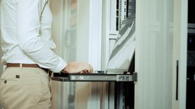 IT Engineer Using Sliding Rack Console Keyboard. Data Center System Administration. Server Maintenance Configuration Troubleshooting Network Hardware. Information Technology Specialist Remote Server - Powered by Shutterstock - Get 15% off with code: PIKWIZARD15